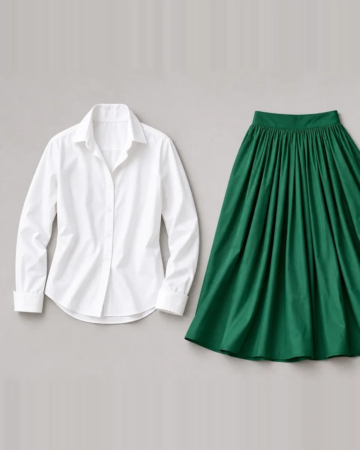 Bright Spring workwear outfit flat lay: clear navy suit, bright ivory shell, emerald scarf and polished gold.