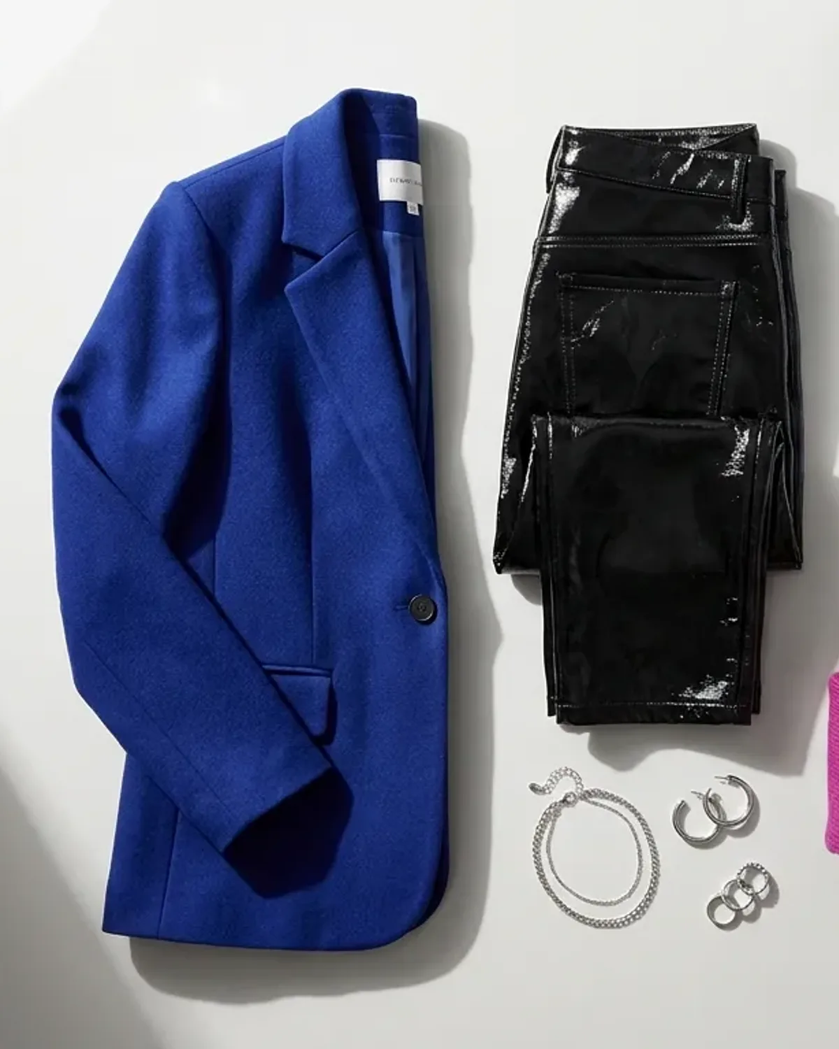 Bright Winter workwear outfit flat lay: black blazer, pure white tee, cobalt trousers and silver.